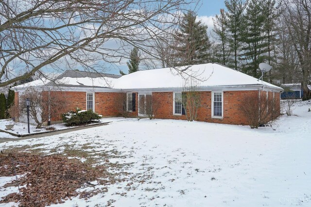 back of property featuring brick siding