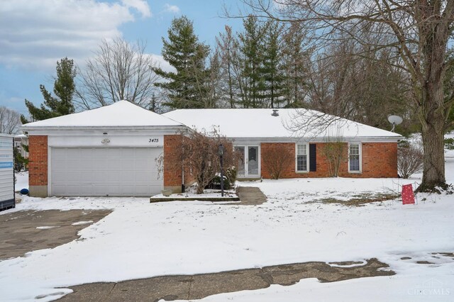 ranch-style house with brick siding and an attached garage