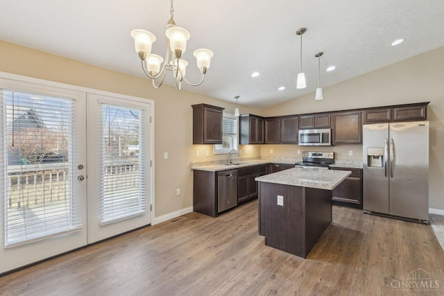 kitchen featuring wood finished floors, stainless steel appliances, dark brown cabinets, and french doors