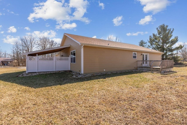 view of property exterior featuring a wooden deck and a yard