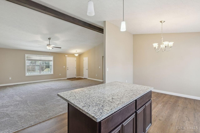 kitchen with vaulted ceiling with beams, ceiling fan with notable chandelier, baseboards, dark brown cabinets, and decorative light fixtures