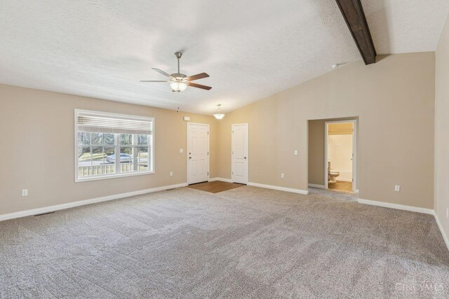 carpeted spare room featuring vaulted ceiling with beams, a textured ceiling, visible vents, a ceiling fan, and baseboards