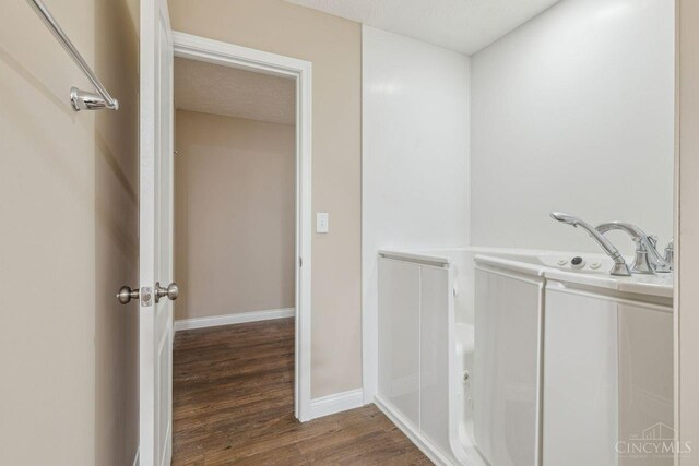 interior space with baseboards and wood finished floors