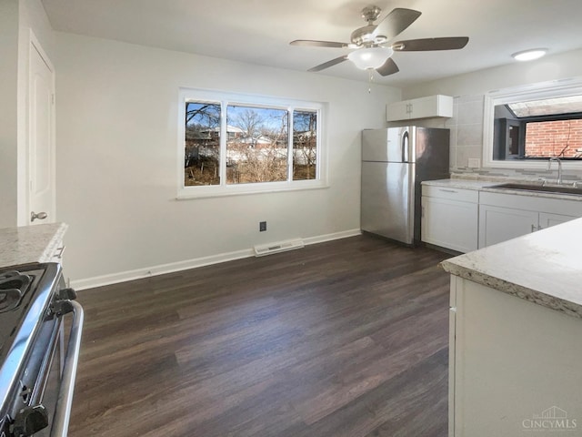 3044 Aries Ct, Colerain Twp, OH 45251 - kitchen with stainless steel appliances, plenty of natural light, a ceiling fan, and dark wood-style flooring
