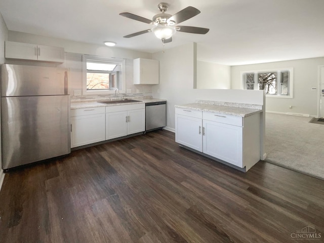 3044 Aries Ct, Colerain Twp, OH 45251 - kitchen featuring stainless steel appliances, white cabinets, a ceiling fan, dark wood-type flooring, and light stone countertops