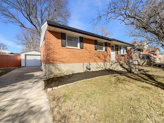 3044 Aries Ct, Colerain Twp, OH 45251 - ranch-style house featuring driveway, brick siding, an outdoor structure, and a detached garage
