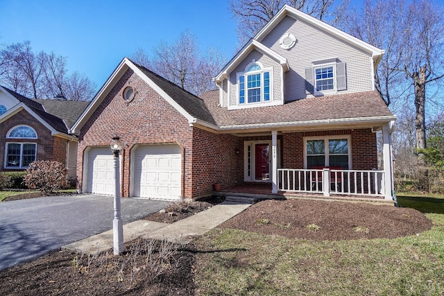 traditional-style home featuring covered porch, driveway, brick siding, and a garage