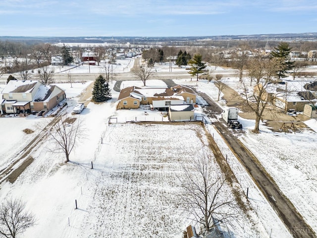 snowy aerial view with a residential view