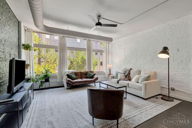 living room with ceiling fan and wood finished floors