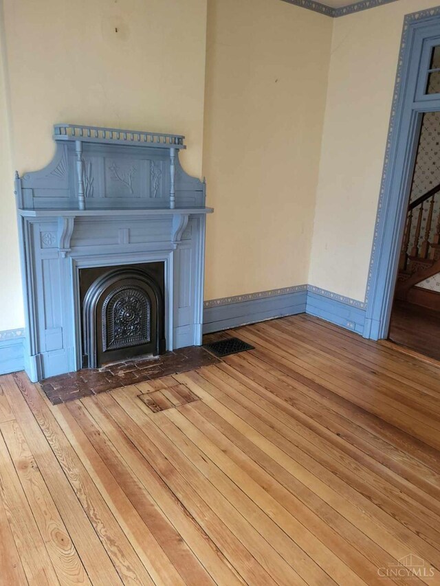 1144 Round Bottom Rd, Union Twp, OH 45150 - room details featuring a fireplace with flush hearth, baseboards, wood finished floors, and visible vents