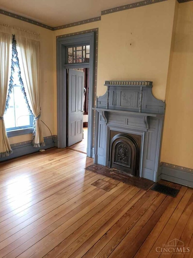 1144 Round Bottom Rd, Union Twp, OH 45150 - unfurnished living room featuring hardwood / wood-style flooring, visible vents, and a fireplace