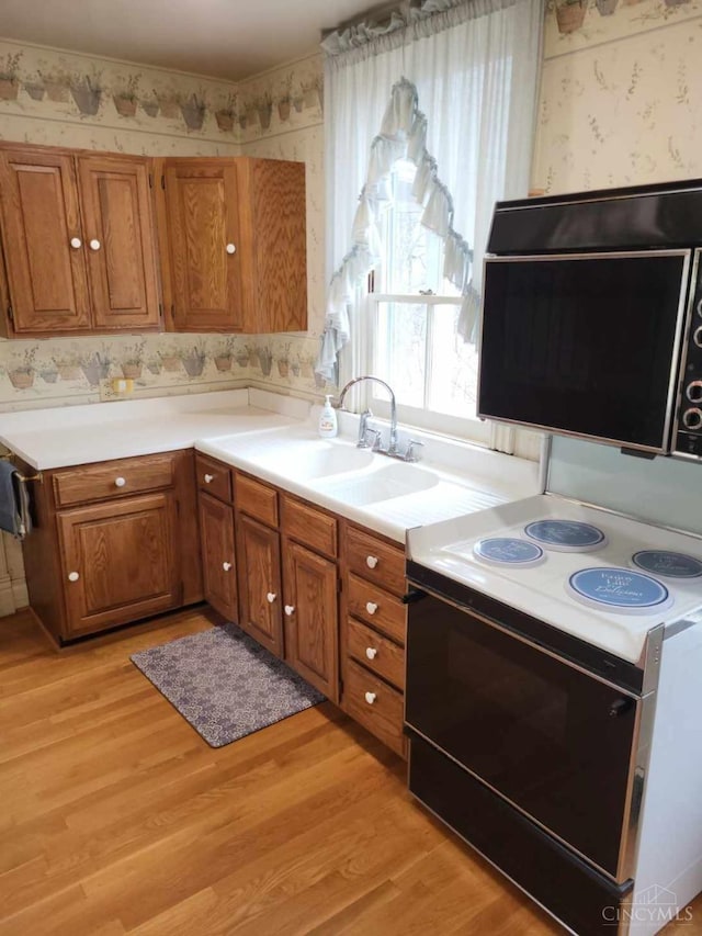 1144 Round Bottom Rd, Union Twp, OH 45150 - kitchen with wallpapered walls, brown cabinets, and electric range