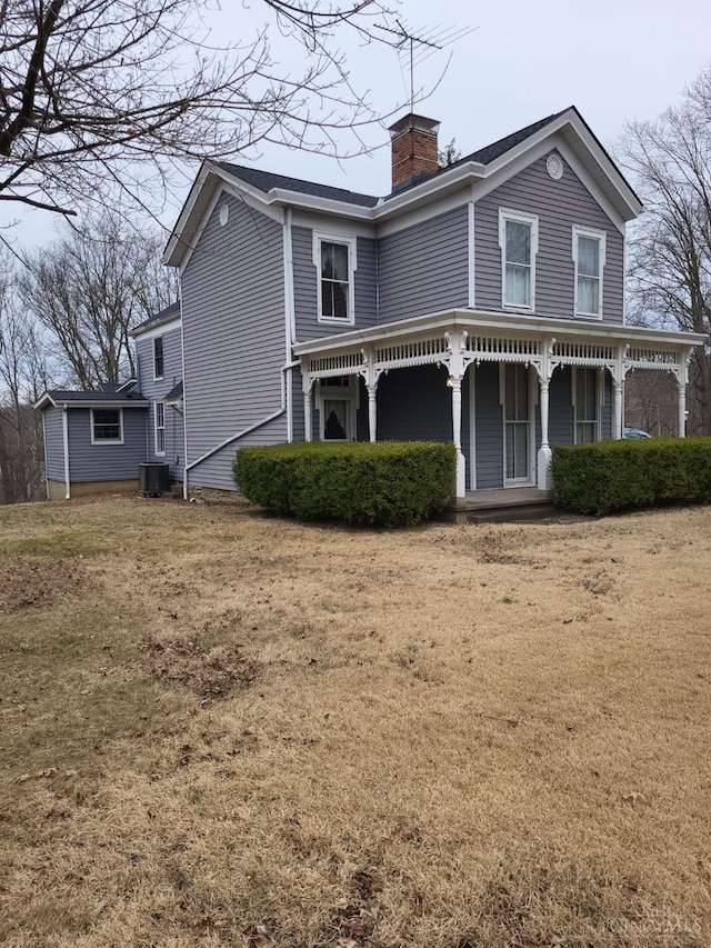 1144 Round Bottom Rd, Union Twp, OH 45150 - view of front of home featuring cooling unit, a front yard, a chimney, and covered porch