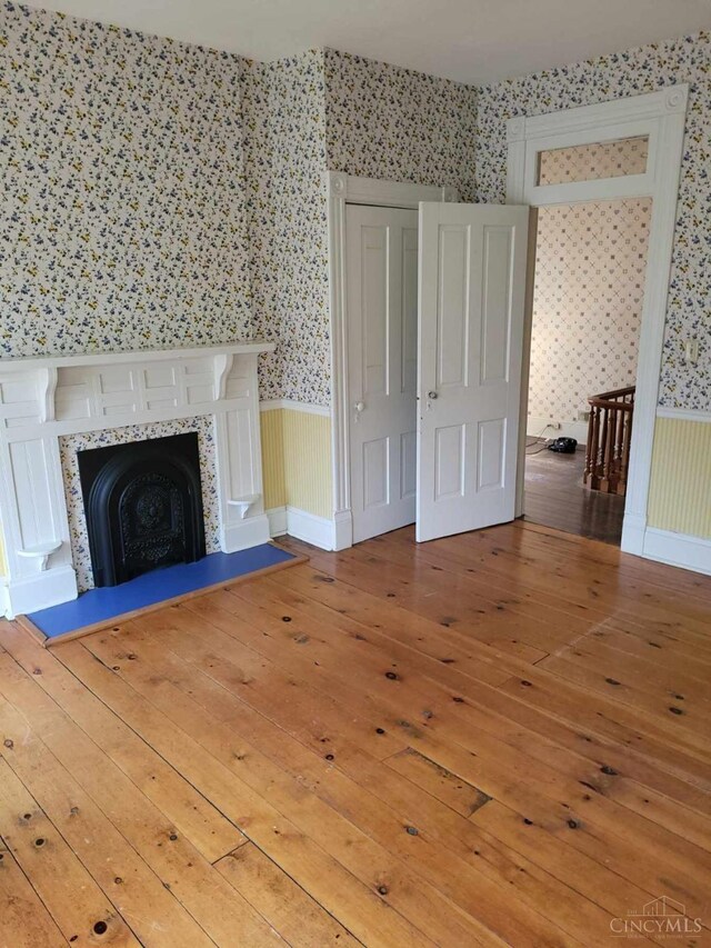 1144 Round Bottom Rd, Union Twp, OH 45150 - unfurnished living room featuring wallpapered walls and wood-type flooring