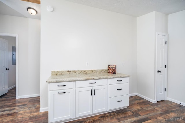 5103 Washburn Rd, Brushcreek Twp, OH 45133 - kitchen featuring dark wood finished floors, light stone counters, white cabinets, and baseboards