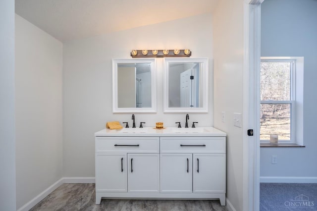 5103 Washburn Rd, Brushcreek Twp, OH 45133 - full bathroom with lofted ceiling, double vanity, and baseboards