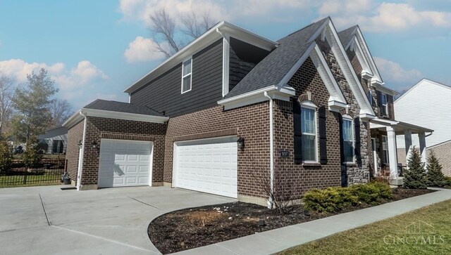 view of home's exterior featuring concrete driveway, an attached garage, brick siding, and a shingled roof
