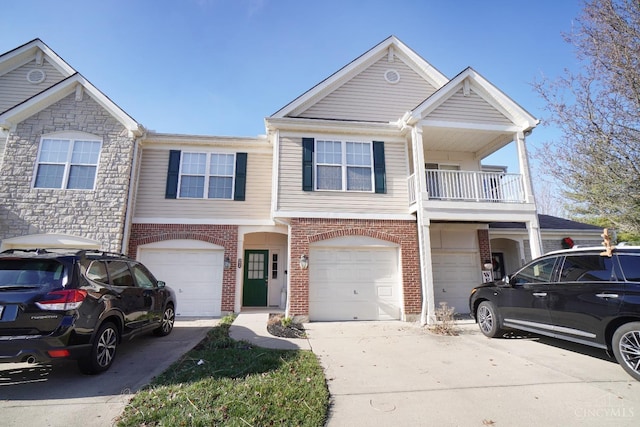 view of property featuring brick siding, an attached garage, and driveway