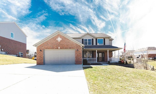 traditional home featuring a porch, an attached garage, brick siding, and a front lawn