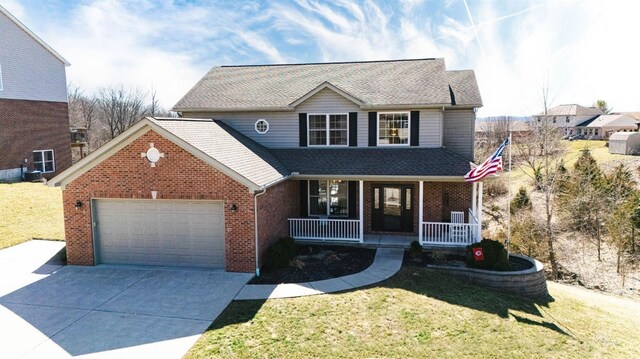 traditional-style house featuring a front lawn, covered porch, concrete driveway, an attached garage, and brick siding