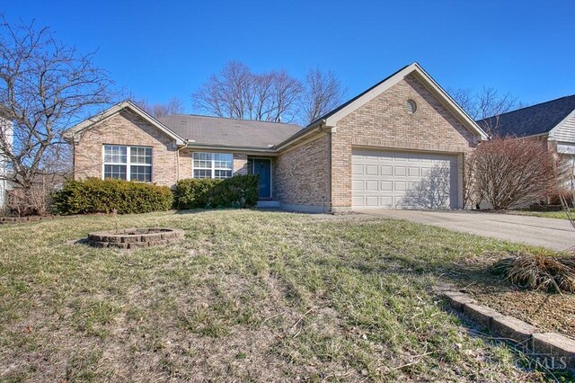 ranch-style home with brick siding, a front lawn, concrete driveway, and a garage