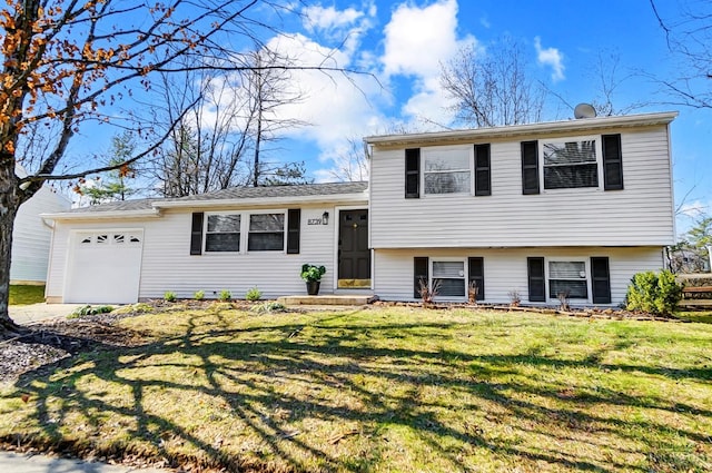 tri-level home with a garage and a front yard