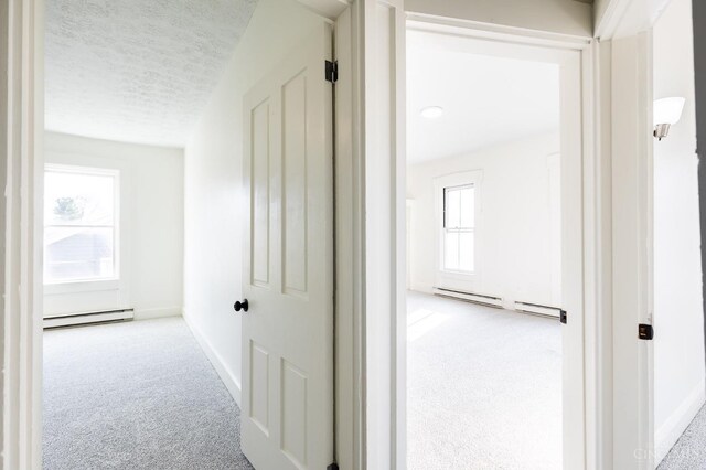 6114 Reily Millville Rd, Reily Twp, OH 45056 - hallway featuring baseboards, baseboard heating, carpet flooring, and a textured ceiling
