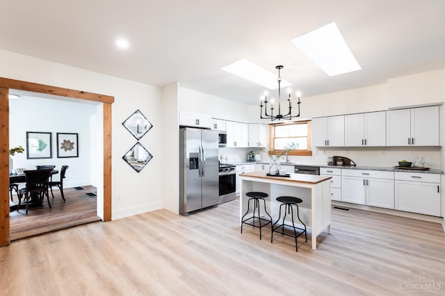 6114 Reily Millville Rd, Reily Twp, OH 45056 - kitchen featuring stainless steel appliances, a notable chandelier, a skylight, and light countertops