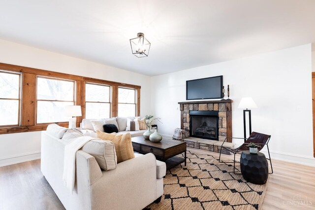 6114 Reily Millville Rd, Reily Twp, OH 45056 - living room with a fireplace, light wood-style floors, and baseboards