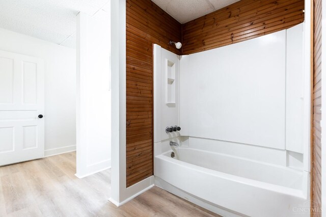 6114 Reily Millville Rd, Reily Twp, OH 45056 - bathroom with wood finished floors, baseboards, wood walls, and shower / washtub combination