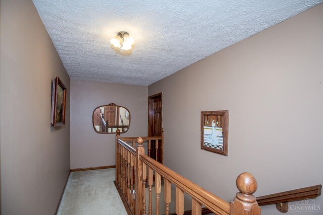 343 Whiteoak Dr, Wilmington, OH 45177 - hallway featuring an upstairs landing, a textured ceiling, light colored carpet, and baseboards