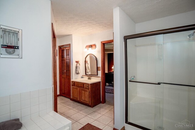 343 Whiteoak Dr, Wilmington, OH 45177 - bathroom with a textured ceiling, vanity, tile patterned floors, and a stall shower