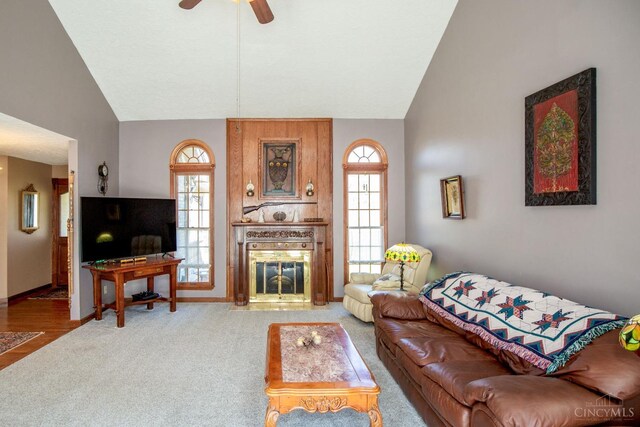 343 Whiteoak Dr, Wilmington, OH 45177 - carpeted living area with lofted ceiling, a fireplace with flush hearth, ceiling fan, and baseboards