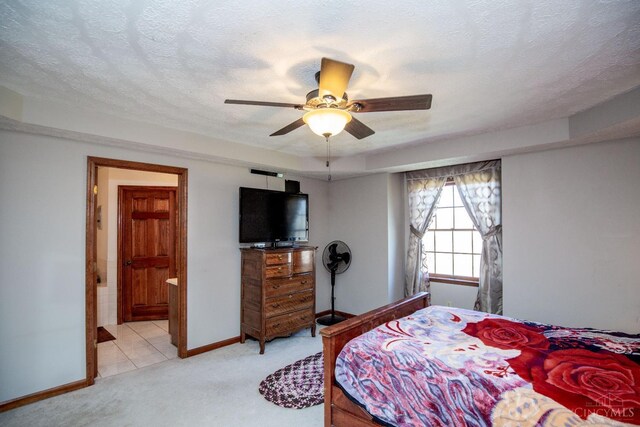 343 Whiteoak Dr, Wilmington, OH 45177 - bedroom featuring light carpet, baseboards, ensuite bath, and a ceiling fan