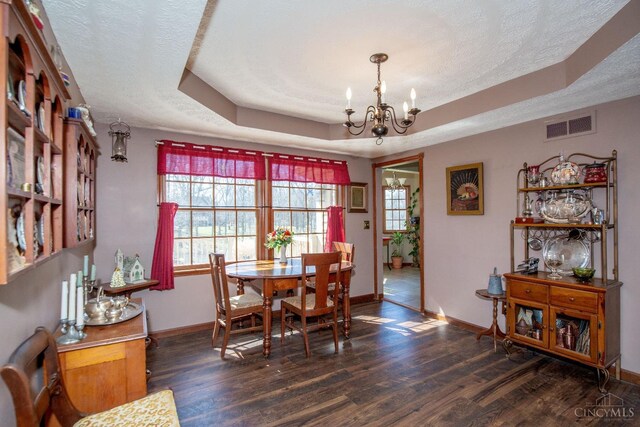 343 Whiteoak Dr, Wilmington, OH 45177 - dining room with a chandelier, a tray ceiling, baseboards, dark wood-style flooring, and a textured ceiling