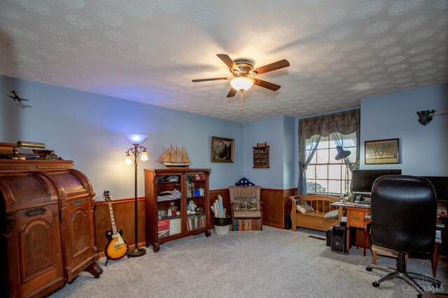 343 Whiteoak Dr, Wilmington, OH 45177 - carpeted home office with a textured ceiling, a ceiling fan, wainscoting, and wood walls