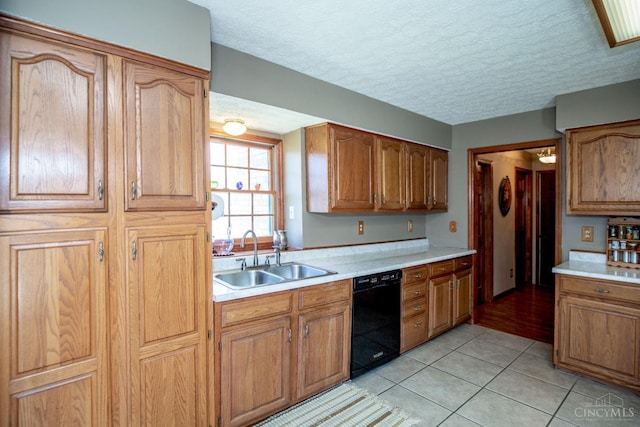 343 Whiteoak Dr, Wilmington, OH 45177 - kitchen with black dishwasher, a sink, light countertops, light tile patterned flooring, and a textured ceiling
