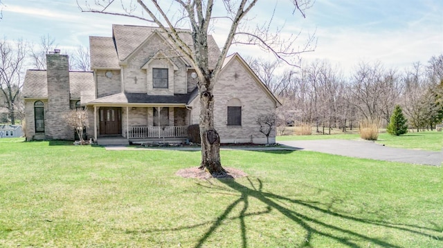 343 Whiteoak Dr, Wilmington, OH 45177 - view of front of house featuring covered porch, a chimney, and a front yard
