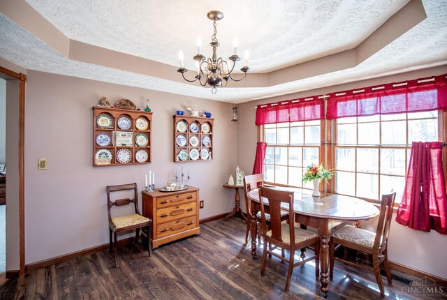 343 Whiteoak Dr, Wilmington, OH 45177 - dining area featuring a textured ceiling, a chandelier, baseboards, dark wood-style flooring, and a raised ceiling