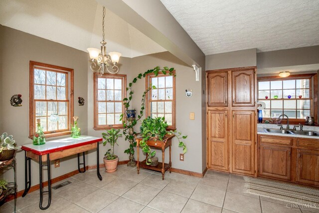 343 Whiteoak Dr, Wilmington, OH 45177 - entryway with a sink, baseboards, a chandelier, light tile patterned flooring, and a textured ceiling