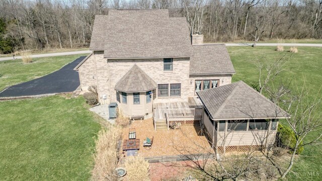 343 Whiteoak Dr, Wilmington, OH 45177 - back of house featuring a chimney, a shingled roof, a yard, and a wooden deck