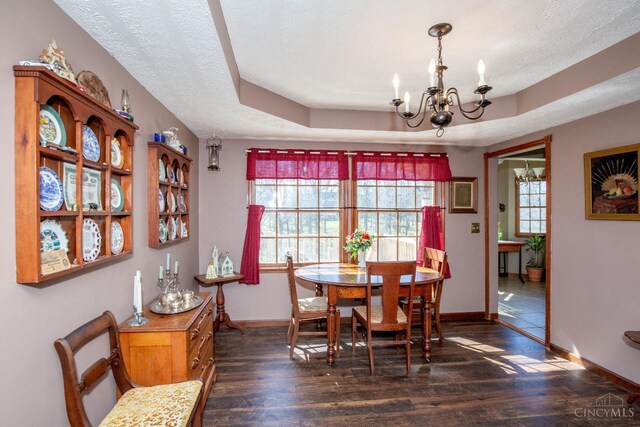 343 Whiteoak Dr, Wilmington, OH 45177 - dining area featuring a chandelier, baseboards, dark wood-style floors, a textured ceiling, and a tray ceiling