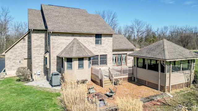 343 Whiteoak Dr, Wilmington, OH 45177 - back of property featuring central AC, brick siding, a deck, and a shingled roof