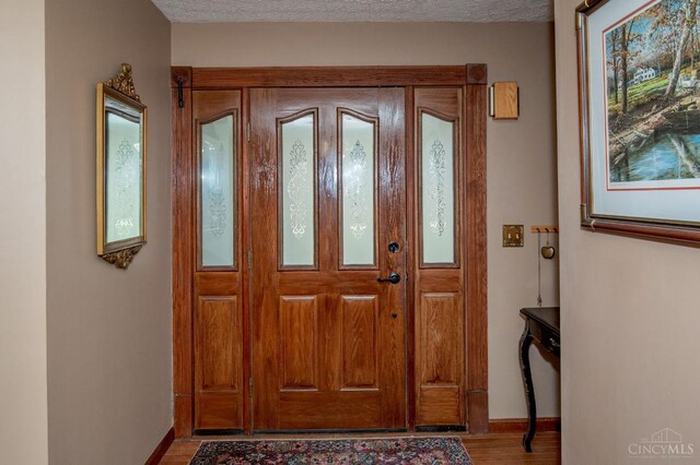 343 Whiteoak Dr, Wilmington, OH 45177 - entrance foyer with baseboards, wood finished floors, and a textured ceiling