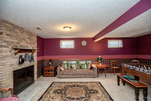 343 Whiteoak Dr, Wilmington, OH 45177 - living area featuring a textured ceiling, a brick fireplace, and a wainscoted wall