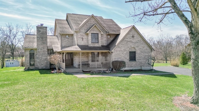 343 Whiteoak Dr, Wilmington, OH 45177 - view of front of home with a porch, a front lawn, brick siding, and roof with shingles