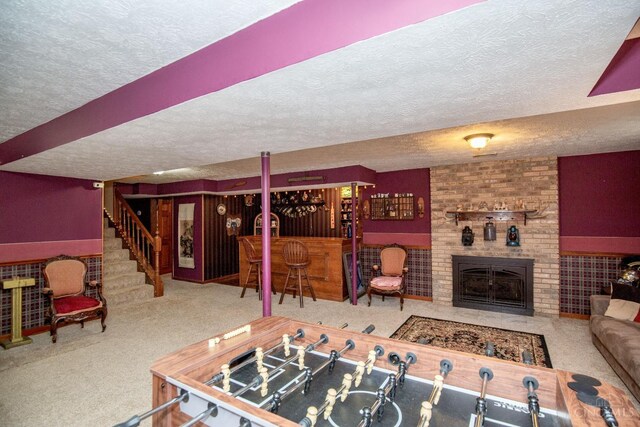 343 Whiteoak Dr, Wilmington, OH 45177 - carpeted living area with a textured ceiling, a dry bar, stairway, and a fireplace