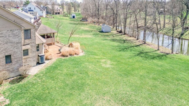 343 Whiteoak Dr, Wilmington, OH 45177 - view of green lawn with a water view, central air condition unit, and an outdoor structure