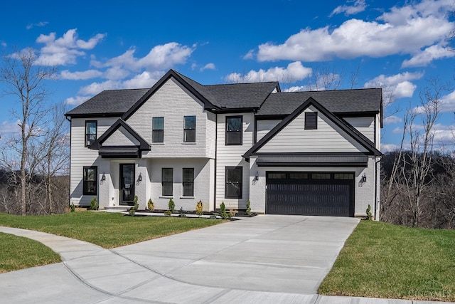 view of front of home featuring driveway, a front yard, and brick siding