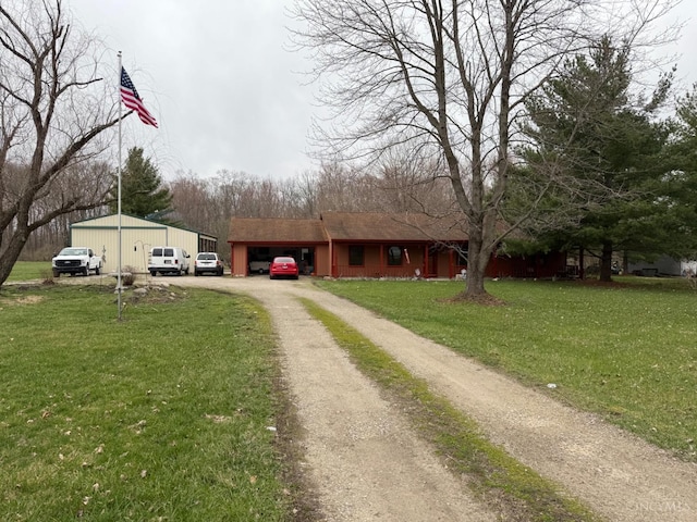 view of front of home with dirt driveway, a garage, and a front yard